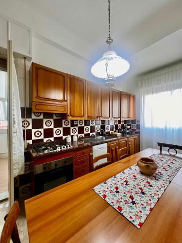 a kitchen with wooden cabinets and a wooden table at Grandmas holiday home Sicily in Giarre