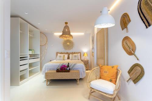 a bedroom with a bed and a chair in it at Mouna's House in Tabaiba