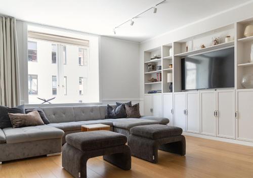 a living room with a couch and a flat screen tv at Central City Apartment in Copenhagen in Copenhagen