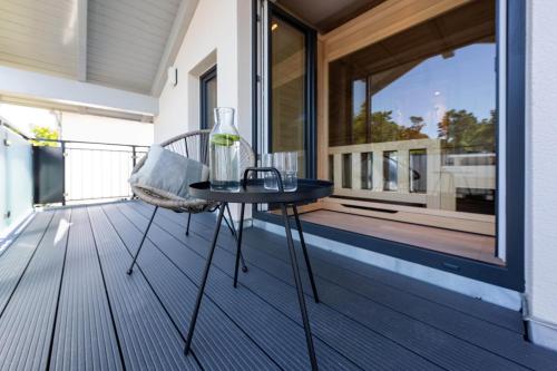 a glass vase sitting on a table on a balcony at Ostsee Apartmenthotel in Graal-Müritz