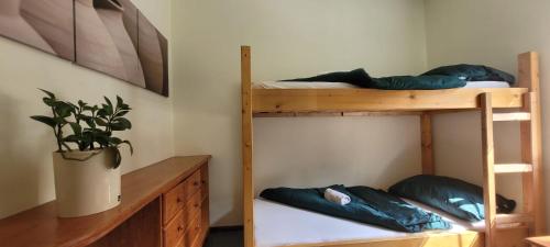 a room with two bunk beds and a desk at Pension Patanka in Prague