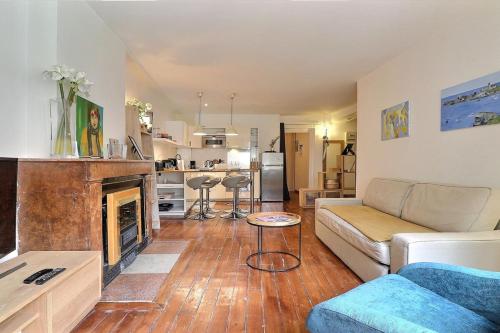 un salon avec un canapé et une cheminée dans l'établissement Le Marius - Beautiful apartment near the Rhône - Lyon 3rd, à Lyon