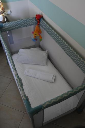 a bunk bed with two pillows and a toy at Πράσινη πινελιά διαμέρισμα in Kissamos