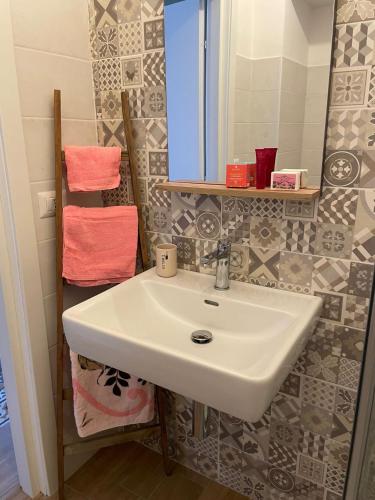 a bathroom with a white sink and a mirror at Il Canto del Gallo in Crotone