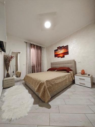 a bedroom with a large bed and a rug at Relais Vittoria in Castel San Lorenzo