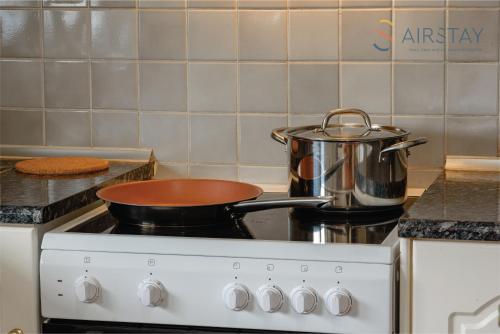 a pot on top of a stove in a kitchen at Zilean Apartments Airport by Airstay in Spáta