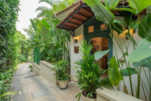 a house with a bunch of plants in front of it at ELIVAAS 3 BHK with Pvt Pool in Assagao -Montforte Ayada in Assagao