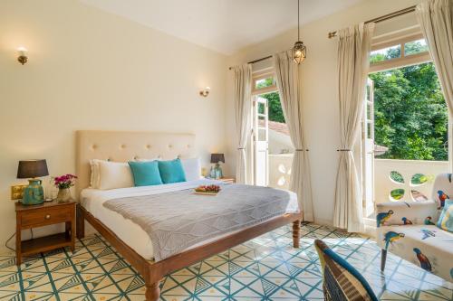 a bedroom with a large bed and a window at ELIVAAS 3 BHK with Pvt Pool in Assagao -Montforte Ayada in Assagao