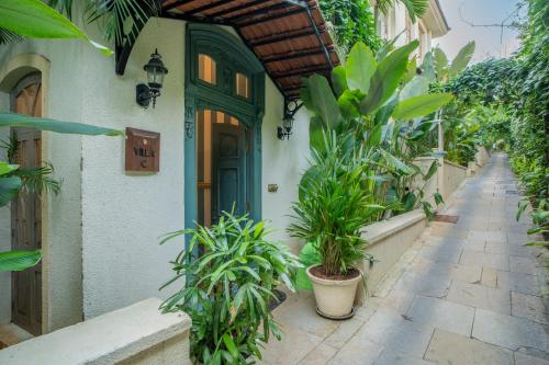 a building with a green door and some plants at ELIVAAS 3 BHK with Pvt Pool in Assagao -Montforte Ayada in Assagao
