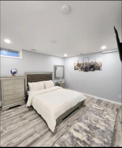 a white bedroom with a large bed and a rug at Perfect House in Pocono with hot tub and sauna steam in Tobyhanna