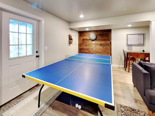 a ping pong court in a living room with a ping pong table at Almost Eden in McHenry