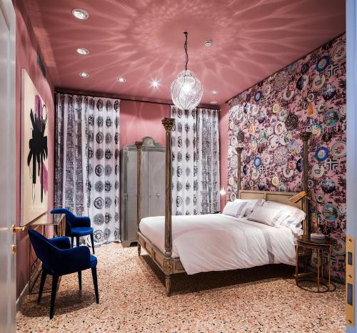 a bedroom with a large bed and a purple ceiling at Hotel Heureka in Venice