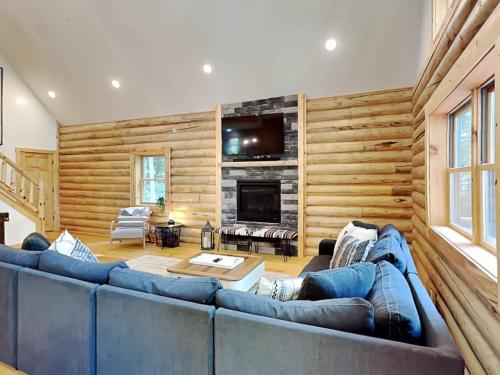 a living room with a blue couch and a fireplace at Almost Eden in McHenry