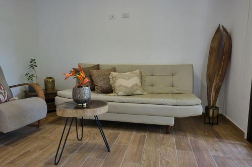a living room with a couch and a table at San Jose Coffee farm in Calarcá