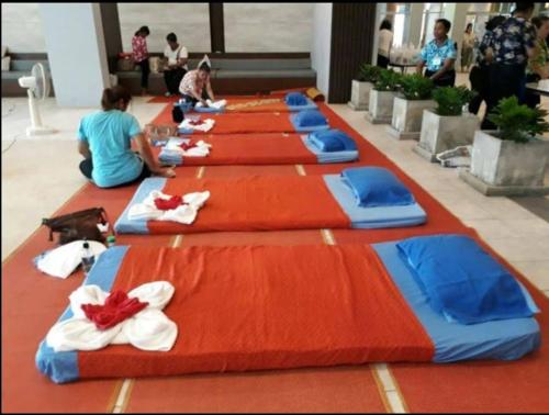 a long line of blue and red beds on a floor at Studio Seaview Jomtien floor12 23sqm in Jomtien Beach