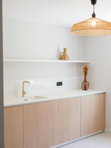 a kitchen counter with a sink and a lamp at Best Western Le Bois de la Marche in Poitiers