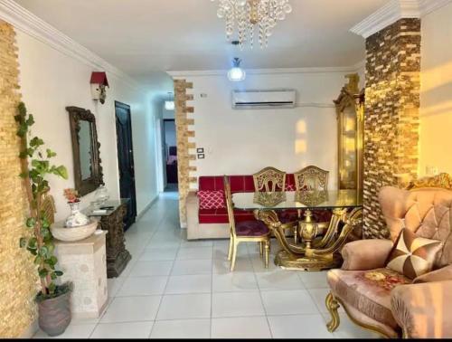 a living room with a table and chairs at Pyramids Suite in Cairo