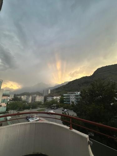 a view of a city with a rainbow in the sky at Maison Familiale - Budget Guest House in Sion