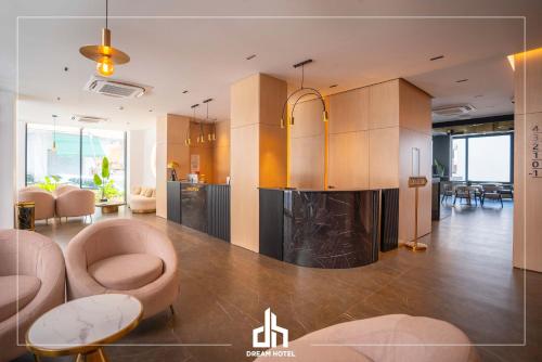a living room with a fireplace and a kitchen at DREAM HOTEL SARANDA in Sarandë