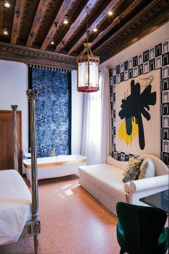 a bedroom with a bed and a tub in it at Hotel Heureka in Venice