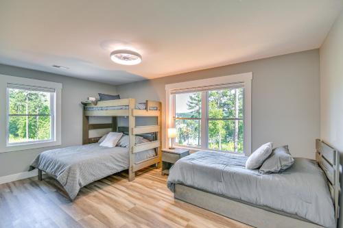 a bedroom with two beds and two windows at Hot Tub and Game Room! Family Connelly Springs Home in Connelly Springs