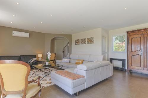 un salon avec un canapé blanc et une table dans l'établissement Soleil de Provence, à Piolenc