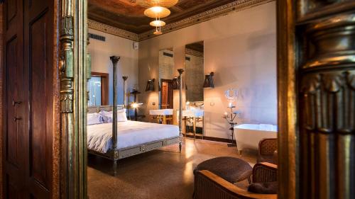 a bedroom with a bed and a tub and a mirror at Hotel Heureka in Venice