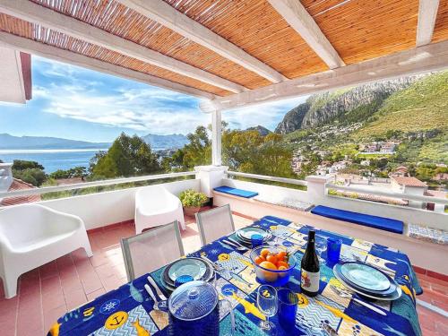 a dining room with a table and a view of the ocean at Solemar Sicilia - Villa dei due Golfi in Santa Flavia