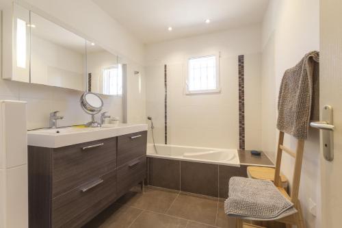 une salle de bain avec un lavabo et une baignoire dans l'établissement Soleil de Provence, à Piolenc