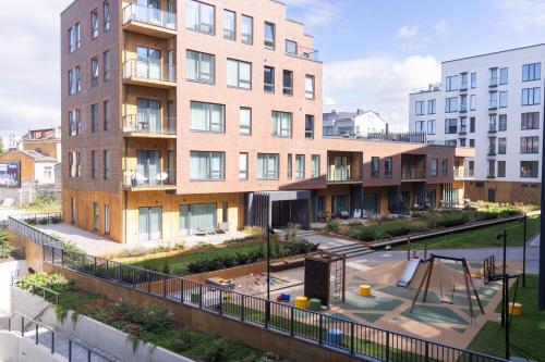 an apartment building with a playground in front of it at Revalia Lastekodu-Odra Bus Station Airport Apartments in Tallinn