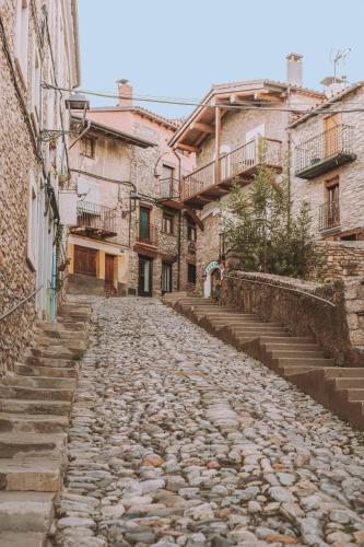 an alley in an old town with stone buildings at Cim's Apartments Cerdanya 1 in Bellver de Cerdanya 