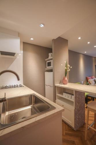 a kitchen with a sink and a counter top at Shinjuku Waseda Hostel in Tokyo
