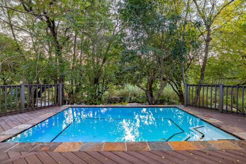 a small blue pool on a deck with trees at Kruger Park Lodge - IKZ2 - 3 Bedroom Chalet in Hazyview