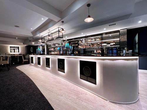 a bar in a restaurant with a white counter at Kiltimagh Park Hotel in Kiltimagh