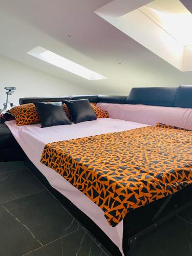 a large bed with a leopard print blanket on it at Apartma Teja-Dekani in Dekani