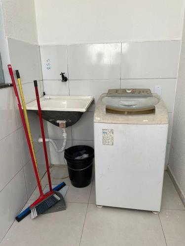 a small bathroom with a sink and a refrigerator at Casa em Petrolina otima localização in Petrolina