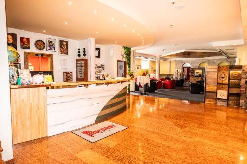 a bar in a restaurant with a counter at Brauhaus zu Murau in Murau