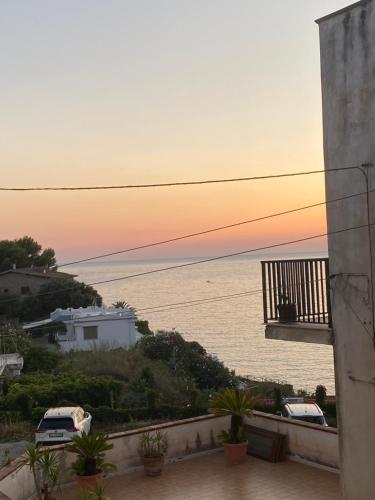 a view of the ocean at sunset from a balcony at Mior Case Vacanze in Palinuro