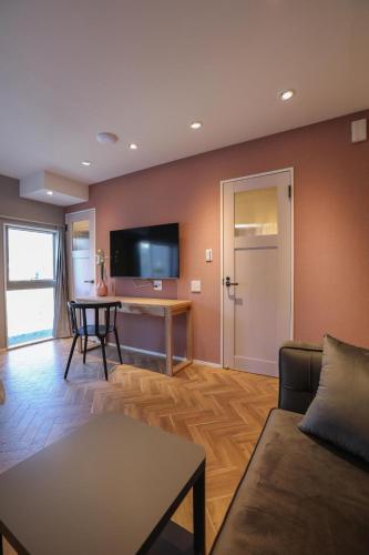 a living room with a couch and a table at Shinjuku Waseda Hostel in Tokyo