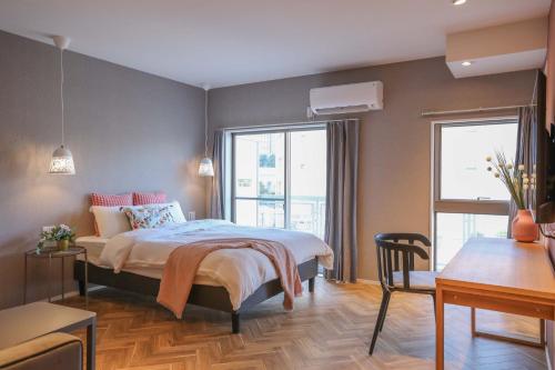 a bedroom with a bed and a table and chairs at Shinjuku Waseda Hostel in Tokyo