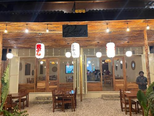 a man standing in front of a restaurant at Roots inn in Paje