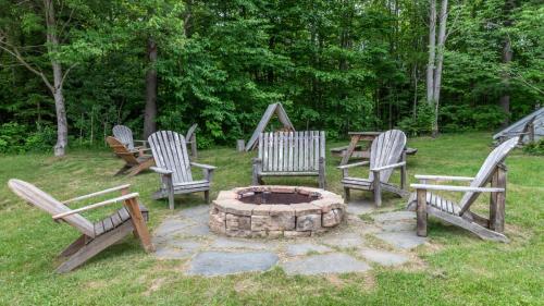 a group of chairs sitting around a fire pit at Bridges Circle condo in Warren