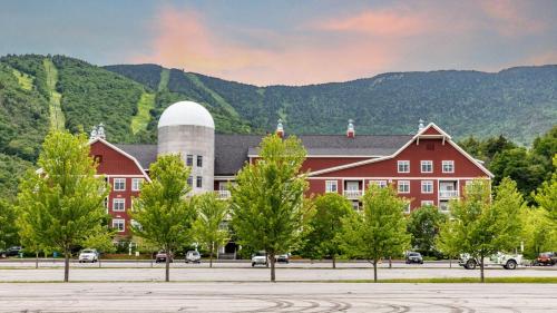 a large red building with a silo in front of a mountain at Bridges Circle condo in Warren