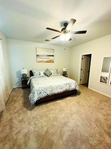 a bedroom with a bed and a ceiling fan at Tiger Tracks Townhome Stay in Baton Rouge - BC1009 in Baton Rouge