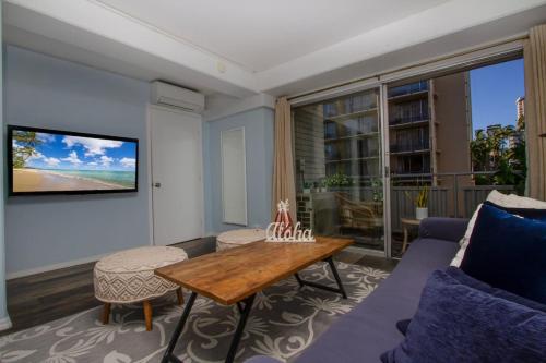 a living room with a couch and a table at Hawaii Style Centrally located with full kitchen in Honolulu