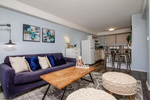 a living room with a purple couch and a table at Hawaii Style Centrally located with full kitchen in Honolulu