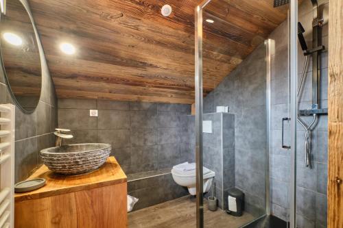 a bathroom with a sink and a toilet at Chalet 2 sur la route du tour in LʼHuez