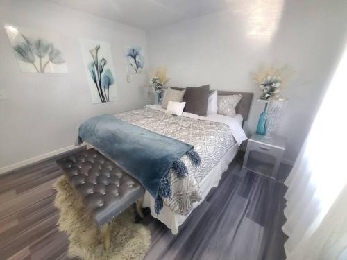 a bedroom with a bed with a blue blanket on it at Heathers Hot tub Hideaway in Middle Grove