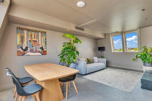 a living room with a table and chairs and a couch at Kings House Apartments in London
