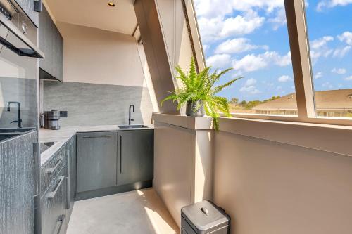 a kitchen with a sink and a window at Kings House Apartments in London